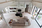 View down into bright living room with white floor