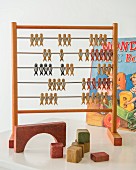 Retro abacus and building blocks in front of colourful picture books in child's bedroom