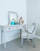 Dressing table with mirror and upholstered chair