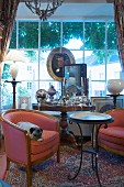 Pug lying on upholstered armchair in front of large lattice window
