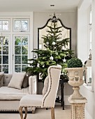 Period furniture and Christmas trees in elegant living room in shades of grey