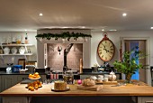 Island counter and Christmas decorations in traditional country-house kitchen