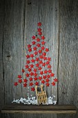 Christmas tree made from red stars on wooden wall