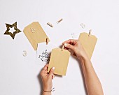 Hands stick wooden clips to small paper bags