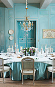 Festively set table in antique dining room with panelled walls