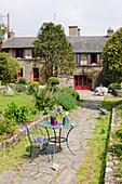 Metal garden furniture in garden of French farmhouse
