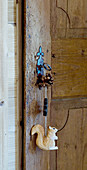 Wooden door with squirrel pendant hung from key