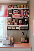 Groceries on kitchen shelves in country-house kitchen