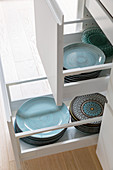 Turquoise crockery in drawer