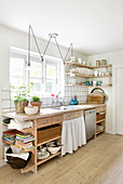Wooden, country-house-style kitchen counter with open-fronted shelves
