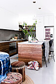 Kitchen island and dining table in front of the open kitchen with boho flair