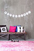 Letters written on garland of doilies decorating wall for party