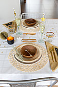 Table festively set in natural shades and with natural materials