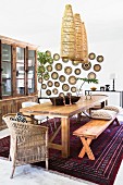Wooden table and wicker lampshades in ethnic-style dining room