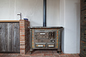Antique kitchen cooker next to masonry kitchen counter