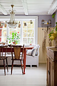 Old chairs at red table in Scandinavian country-house kitchen