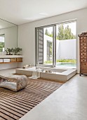Sunken bathtub in elegant bathroom with view of pool