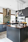 Island counter in American country-house kitchen with grey cupboards