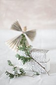 Gift wrapped in pages of book with fir sprig