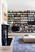 Large bookcase in the living room with an open fireplace