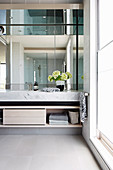 Modern bathroom with mirrored wall and ceiling