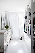 Dressing room with modern closet and vintage chest of drawers