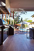 Covered terrace with outdoor kitchen, pool in the background