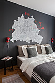 Map of Berlin on black wall above bed