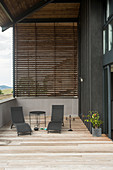 Two loungers on roofed terrace