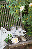 Tealights in wind glasses on weathered garden chair