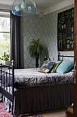 Metal bed with valance in glamorous bedroom