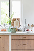 Modern country-house kitchen with pale wooden fronts and vintage-style accessories