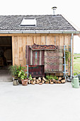 Ethnic rug hung from frame outside barn