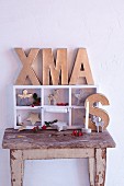 Festive arrangement with cardboard letters spelling XMAS