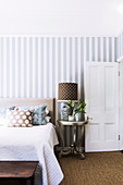 Blue and white striped wallpaper in the bedroom