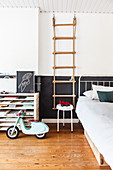 Rope ladder next to bed in boy's bedroom