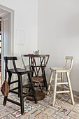 Tall bistro table and vintage barstools in corner of kitchen