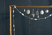 Old Christmas decorations in gilt picture frame