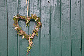 Heart-shaped wreath of birch twigs, hay, box, bark, waxflowers and raffia