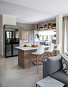 Kitchen island and zigzag wallpaper in open-plan kitchen