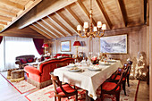 Set table in opulent interior with wood-beamed ceiling