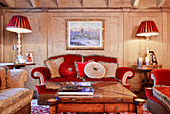 Opulent velvet sofas in red and grey in luxurious living room
