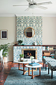 Patterned wallpaper on chimney breast and ceiling fan in living room