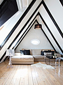 Elegant attic living room with black ceiling beams