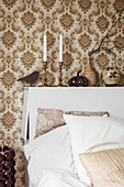 Retro wallpaper and bed headboard with storage space in bedroom