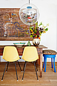Shell chairs and transparent spherical lamp in ethnic dining room