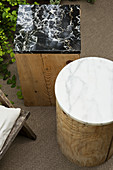 Marble top on wooden block used as side table in garden