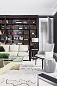 Dark shelf in elegant living room with light sofa and carpet