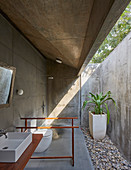 Modern bathroom made from rough concrete in architect-designed house