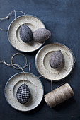 Easter eggs wrapped in fabric and reel of twine